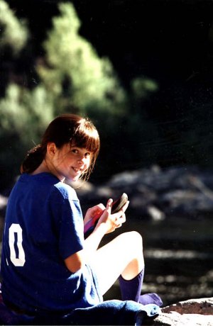 Young girl smiling on river